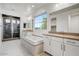 Bright bathroom features a soaking tub, double vanity, large windows and walk-in glass shower showcasing luxurious finishes at 970 W Zion Way, Chandler, AZ 85248