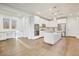 Spacious kitchen featuring white cabinets, stainless steel appliances, a center island, and desk area for added functionality at 970 W Zion Way, Chandler, AZ 85248
