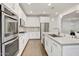 Modern kitchen boasting stainless steel appliances, white cabinetry, a stylish backsplash, and an island with a sink at 970 W Zion Way, Chandler, AZ 85248