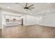 Open concept living room showcasing wood floors, white walls, a modern ceiling fan, and seamless flow into the kitchen at 970 W Zion Way, Chandler, AZ 85248