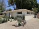 Ranch-style home with desert landscaping, shutters, and an exterior AC unit on a sunny day at 1022 E Keim Dr, Phoenix, AZ 85014