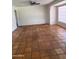Neutral living room with tile flooring, ceiling fan, and natural light from a window at 1022 E Keim Dr, Phoenix, AZ 85014