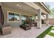 Spacious backyard patio with outdoor dining area, lounge furniture, and a modern fire pit at 1026 N 152Nd Ave, Goodyear, AZ 85338