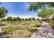 Beautiful community park with lush green grass and winding sidewalk at 1026 N 152Nd Ave, Goodyear, AZ 85338