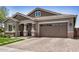 Charming home featuring a paved driveway, brick accents, and a two-car garage at 1026 N 152Nd Ave, Goodyear, AZ 85338