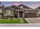 Charming single-story home with well-manicured lawn, brick accents, and a two-car garage at 1026 N 152Nd Ave, Goodyear, AZ 85338