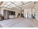 Spacious garage featuring epoxy flooring, storage cabinets, and fitness equipment at 1026 N 152Nd Ave, Goodyear, AZ 85338