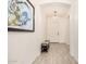 Inviting hallway with neutral tones, tile floors, and modern light fixture offers a welcoming entrance at 1026 N 152Nd Ave, Goodyear, AZ 85338