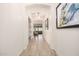 Inviting hallway with wood-look tile, archways, and views into the living spaces at 1026 N 152Nd Ave, Goodyear, AZ 85338