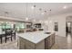 Bright kitchen featuring a large island, ample counter space, and stainless steel appliances at 1026 N 152Nd Ave, Goodyear, AZ 85338