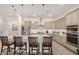 Gourmet kitchen boasts large island, stainless steel appliances, designer backsplash, and modern pendant lighting at 1026 N 152Nd Ave, Goodyear, AZ 85338