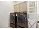 Bright laundry room featuring modern appliances and ample cabinet storage space at 1026 N 152Nd Ave, Goodyear, AZ 85338