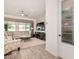 Bright living room featuring wood-look tile flooring, large windows, comfortable seating, and ceiling fan at 1026 N 152Nd Ave, Goodyear, AZ 85338