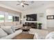 Comfortable living room with a large window, modern entertainment center, and stylish furnishings at 1026 N 152Nd Ave, Goodyear, AZ 85338