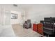 Spacious office area features French doors, comfortable seating, wood-look tile flooring, and lots of light at 1026 N 152Nd Ave, Goodyear, AZ 85338