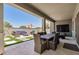 Covered patio with dining set, outdoor seating, and a beautiful view of the backyard at 1026 N 152Nd Ave, Goodyear, AZ 85338