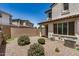 Low-maintenance backyard with gravel, shrubbery, and block wall, offering private outdoor space at 1153 W Diamondback Dr, Chandler, AZ 85286