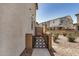 Gated entrance to a gravel backyard with desert landscaping and neighboring homes at 1153 W Diamondback Dr, Chandler, AZ 85286