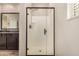 Modern bathroom featuring a glass-enclosed shower and dark wood cabinets at 1153 W Diamondback Dr, Chandler, AZ 85286