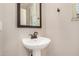 Charming powder room featuring a sleek pedestal sink and framed mirror at 1153 W Diamondback Dr, Chandler, AZ 85286