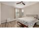 Comfortable bedroom with a ceiling fan and wood-look laminate flooring at 1153 W Diamondback Dr, Chandler, AZ 85286