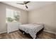 Bright bedroom with window and hardwood floors, complete with dresser at 1153 W Diamondback Dr, Chandler, AZ 85286