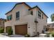 Two-story home with brown garage doors, stucco exterior, and decorative window accents at 1153 W Diamondback Dr, Chandler, AZ 85286