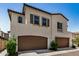 Two-story home with stucco exterior and brown garage doors at 1153 W Diamondback Dr, Chandler, AZ 85286