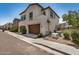 Two-story home with brown garage doors, stucco exterior, and decorative window accents at 1153 W Diamondback Dr, Chandler, AZ 85286