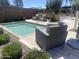The community hot tub area is surrounded by lush greenery and stylish outdoor seating at 1153 W Diamondback Dr, Chandler, AZ 85286