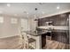 Open kitchen featuring stainless steel appliances, center island, and dark cabinets at 1153 W Diamondback Dr, Chandler, AZ 85286