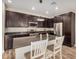 Open kitchen featuring stainless steel appliances, center island, and dark cabinets at 1153 W Diamondback Dr, Chandler, AZ 85286