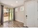 Neutral room with wood floors, sliding glass door, and plantation shutters at 1153 W Diamondback Dr, Chandler, AZ 85286