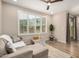 Bright living room with wood floors, ceiling fan, neutral sofa, and large windows at 1153 W Diamondback Dr, Chandler, AZ 85286