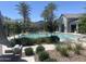 A community pool surrounded by tropical plants, chaise lounges, and a cabana at 1153 W Diamondback Dr, Chandler, AZ 85286