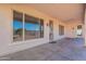 Covered back patio with exterior lighting and a view of the desert landscaping at 12910 W Junipero Dr, Sun City West, AZ 85375