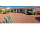 This backyard features desert landscaping and a covered patio, perfect for relaxing or entertaining at 12910 W Junipero Dr, Sun City West, AZ 85375