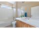 Full bathroom with a tub, a shower, a toilet, a framed mirror, and a sink at 12910 W Junipero Dr, Sun City West, AZ 85375