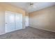 Neutral bedroom with carpeted floor, closet with doors, and a ceiling fan at 12910 W Junipero Dr, Sun City West, AZ 85375