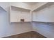 Walk-in closet with carpeted floor and ample white shelving at 12910 W Junipero Dr, Sun City West, AZ 85375