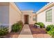 Inviting front entryway with desert landscaping and cozy bench at 12910 W Junipero Dr, Sun City West, AZ 85375