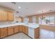 Bright kitchen features wooden cabinetry, white countertops and flows nicely into the dining spaces at 12910 W Junipero Dr, Sun City West, AZ 85375