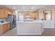Bright kitchen featuring wooden cabinets, stainless appliances and breakfast bar at 12910 W Junipero Dr, Sun City West, AZ 85375