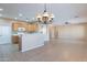 Bright kitchen and connecting living area featuring wooden cabinets and stainless appliances at 12910 W Junipero Dr, Sun City West, AZ 85375