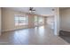 Spacious living room with tile flooring, ceiling fan, and plenty of natural light at 12910 W Junipero Dr, Sun City West, AZ 85375