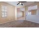 Cozy living room with neutral paint colors, a large window and a view into the dining space at 12910 W Junipero Dr, Sun City West, AZ 85375