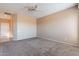 Spacious main bedroom with neutral paint, carpet flooring, ceiling fan and a walk in closet at 12910 W Junipero Dr, Sun City West, AZ 85375