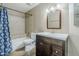 Cozy bathroom featuring a shower-tub combination, a vanity with a sink, and neutral wall paint at 1311 N Congress Dr, Chandler, AZ 85226