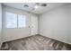 Simple, carpeted bedroom with a window and a ceiling fan, offering a calm and neutral space at 1311 N Congress Dr, Chandler, AZ 85226