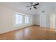 Large bedroom with hardwood floors, vaulted ceilings, fan, and natural light from windows at 1311 N Congress Dr, Chandler, AZ 85226